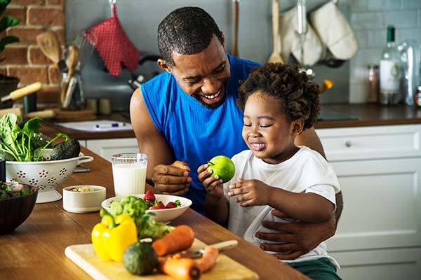 Dad and son eating healthy food together